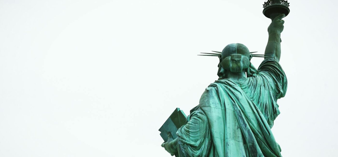 The Statue of Liberty stands tall against a clear sky, symbolizing freedom in New York City.